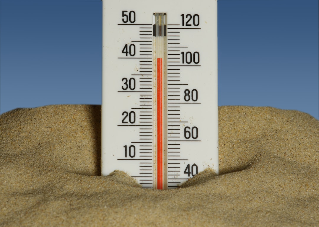 A close-up of a compost pile with a thermometer showing 140 degrees, illustrating the 4:1:1 ratio in action